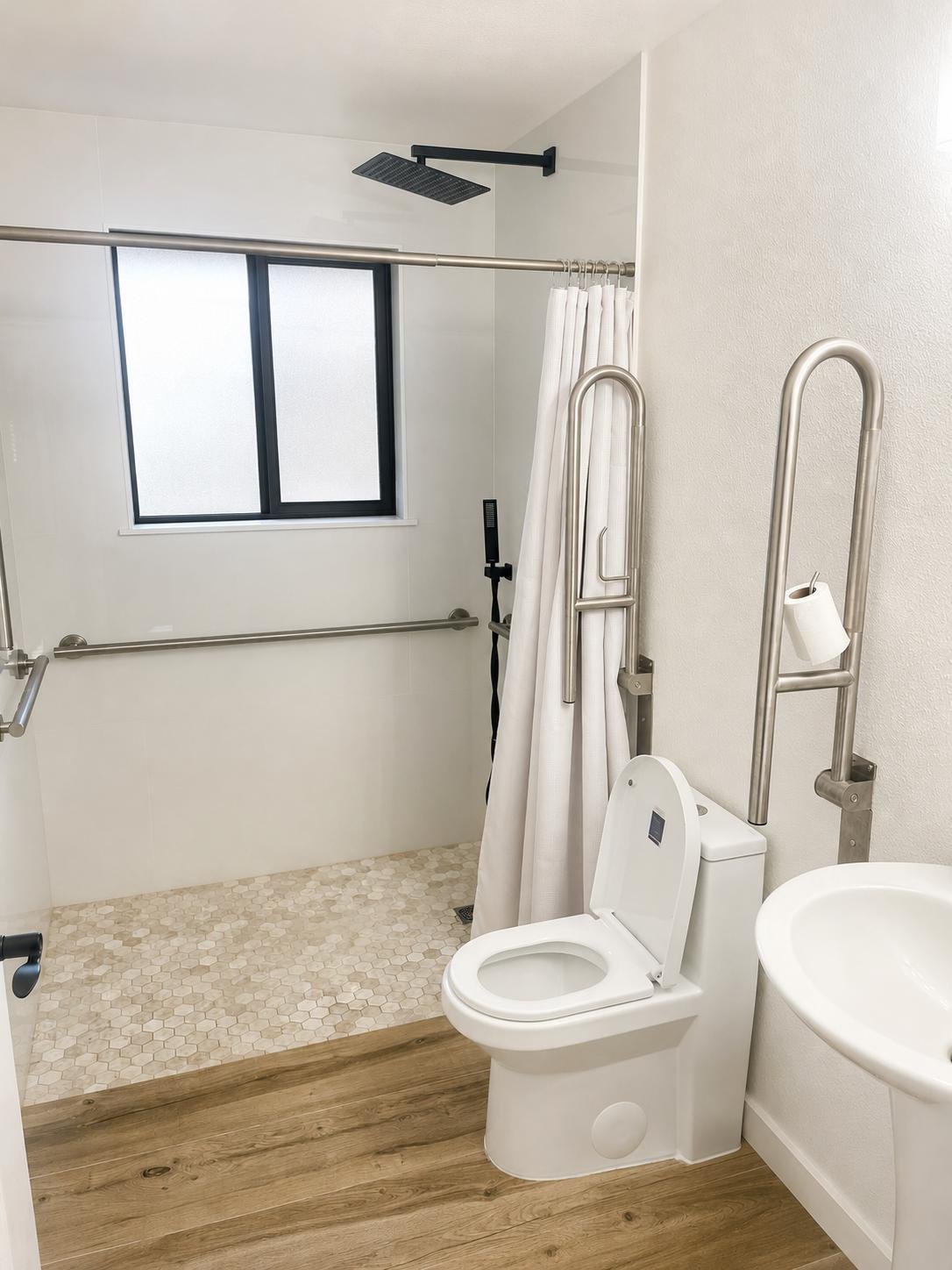 Accessible bathroom with grab bars and a curtained shower